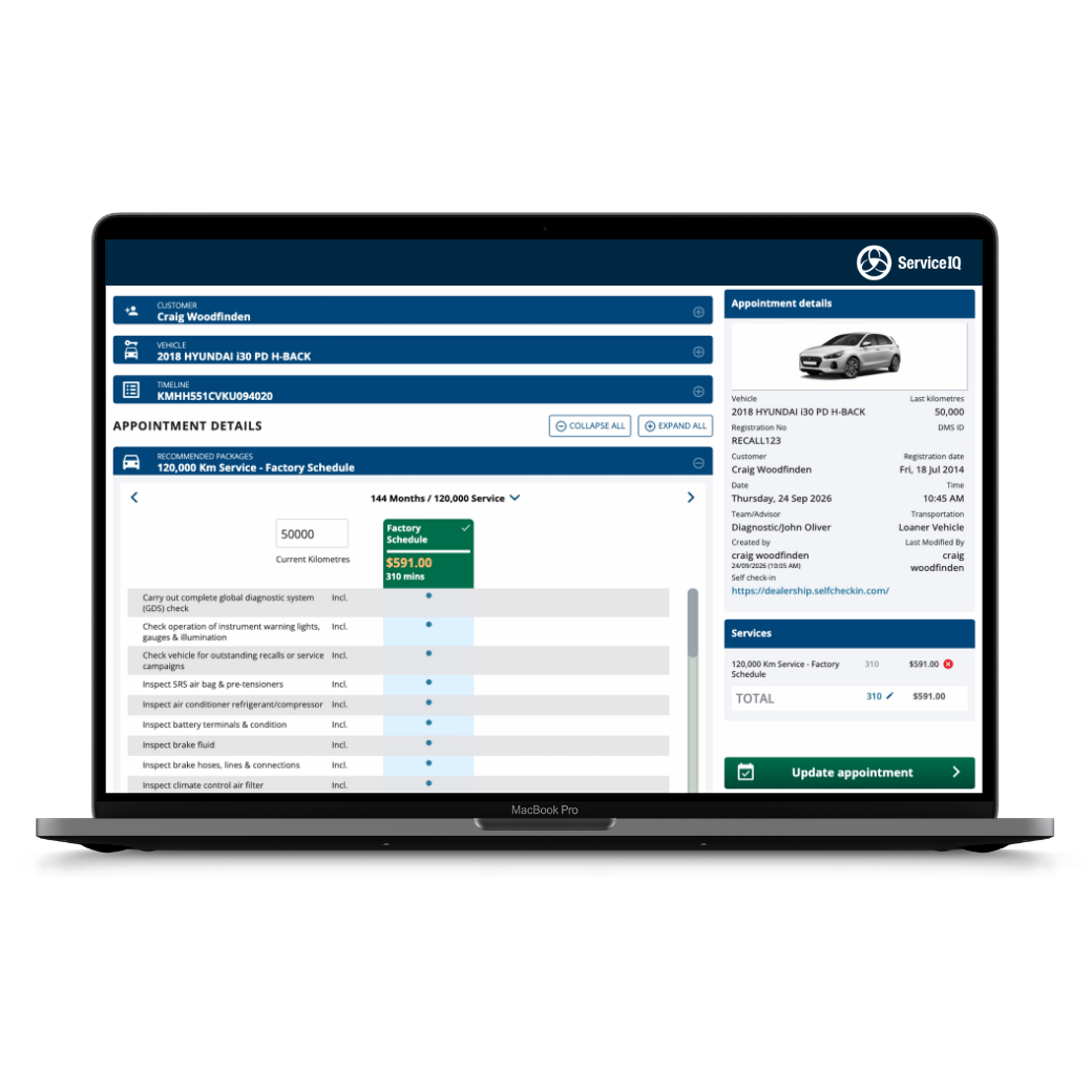ServiceIQ scheduling screen on a laptop showing appointment details, recommended service packages and available time slots